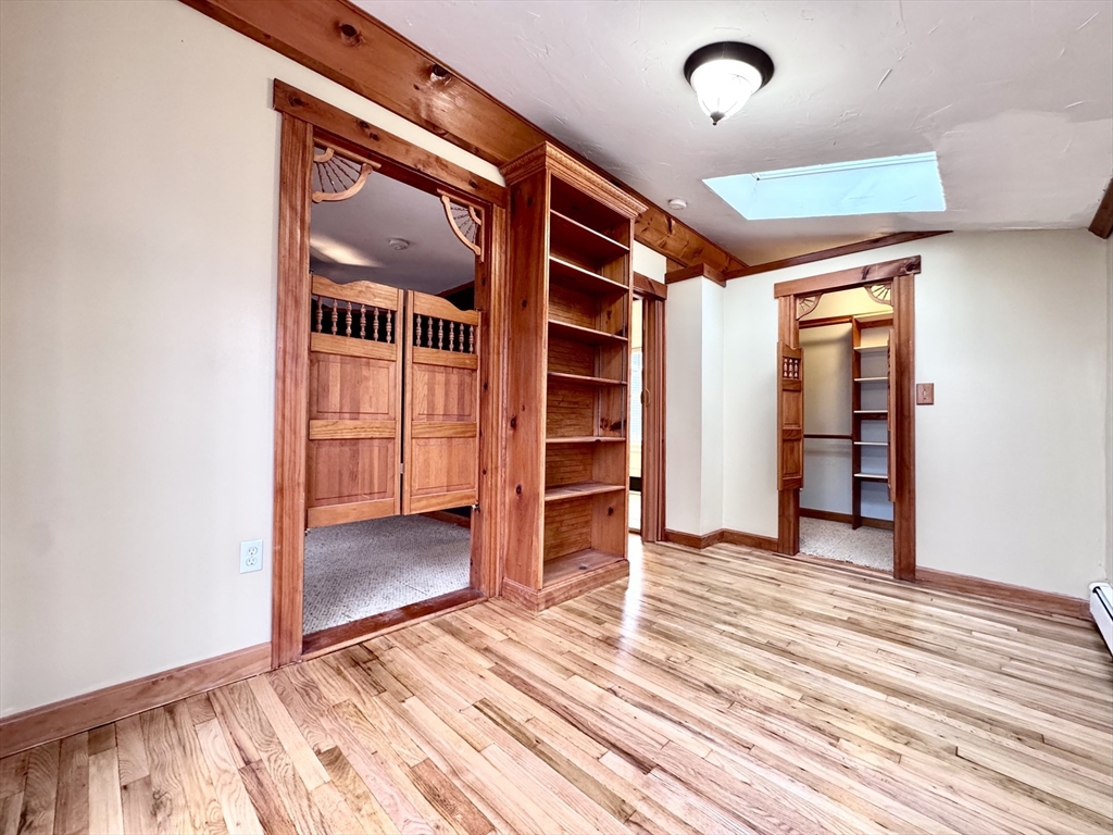 53 Circuit Road Dedham, MA 02026 - Photo 12 of 26 an empty room with wooden floor and closet