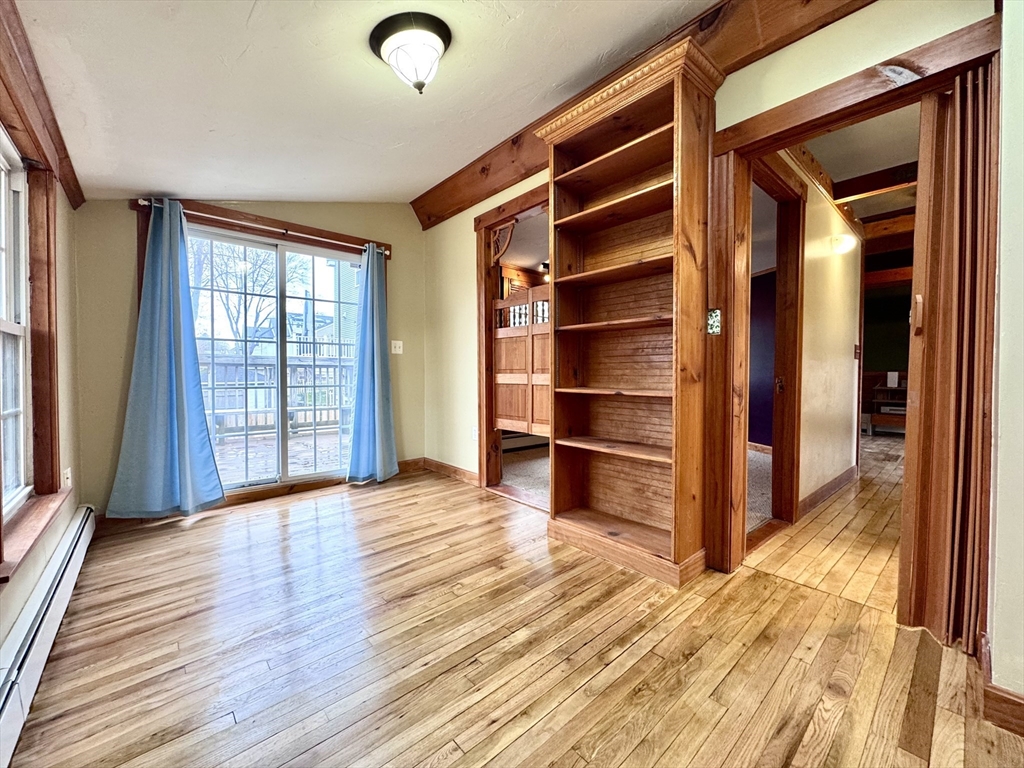 53 Circuit Road Dedham, MA 02026 - Photo 14 of 26 a view of an empty room with a window and wooden floor