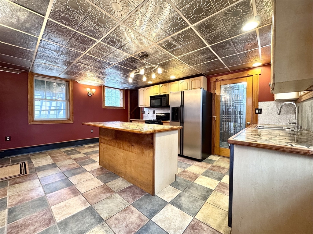 53 Circuit Road Dedham, MA 02026 - Photo 19 of 26 a kitchen with stainless steel appliances granite countertop a sink stove and refrigerator