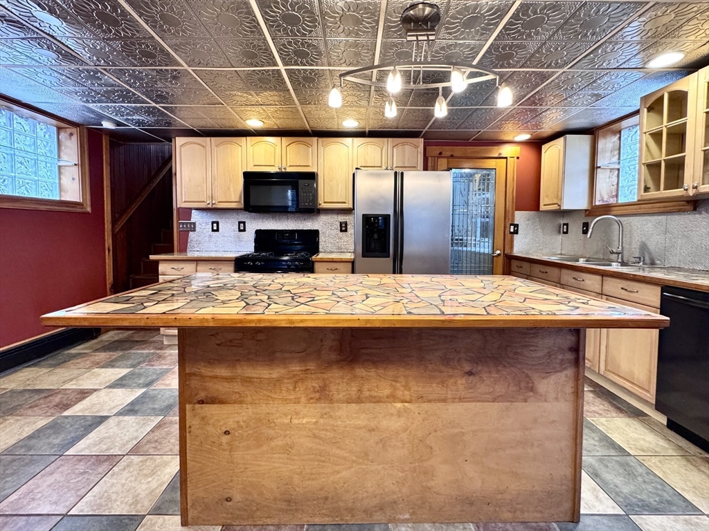 53 Circuit Road Dedham, MA 02026 - Photo 20 of 26 a view of a kitchen with a sink and wooden floor