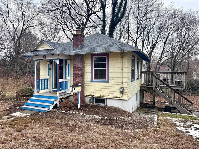 a view of house with a yard and the trees