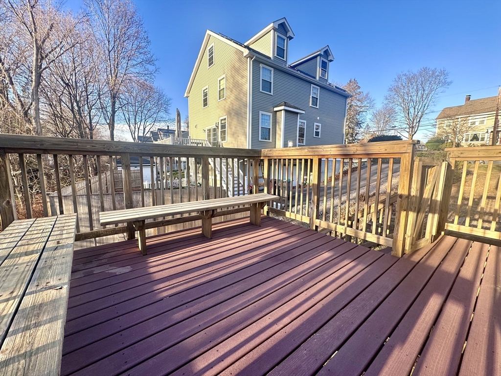 53 Circuit Road Dedham, MA 02026 - Photo 23 of 26 a view of a wooden deck with a bench