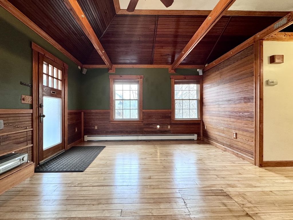 53 Circuit Road Dedham, MA 02026 - Photo 5 of 26 a view of an empty room with wooden floor and a window