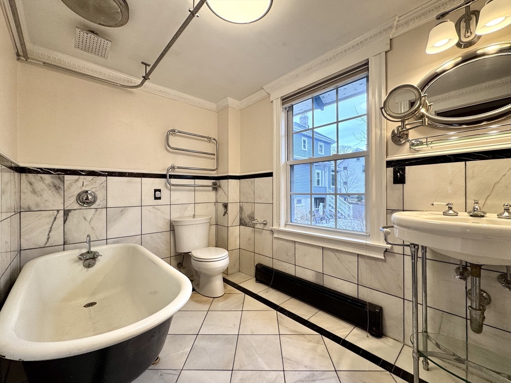 53 Circuit Road Dedham, MA 02026 - Photo 7 of 26 a bathroom with a sink and a bathtub