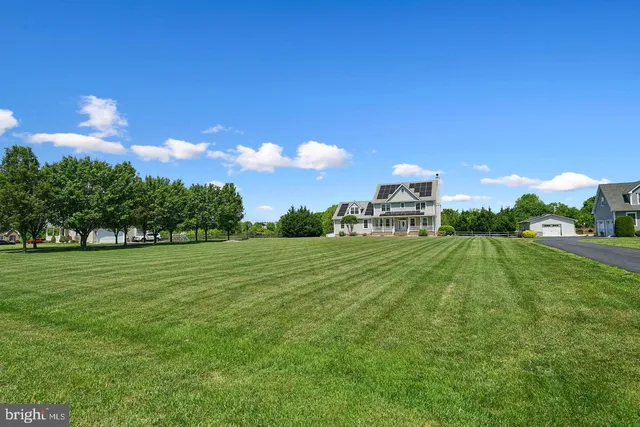 a view of a green field with sitting area