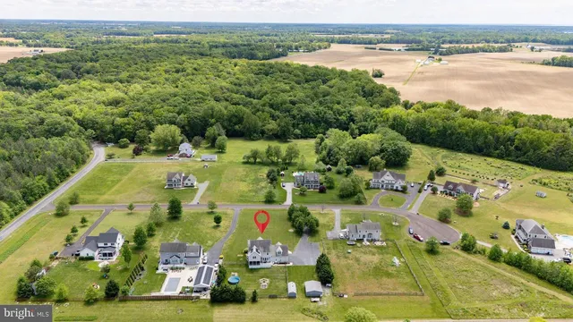 an aerial view of residential houses with outdoor space