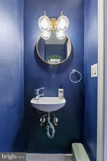 a bathroom with a toilet a sink and a mirror