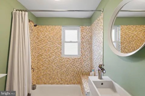 a bathroom with a bathtub and shower