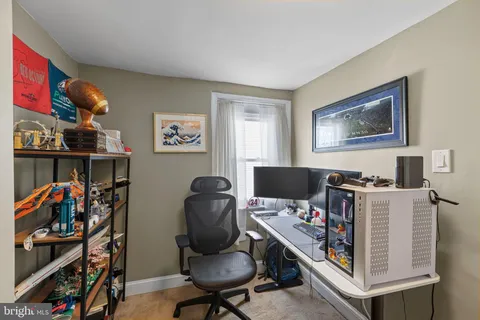 a view of a workspace with furniture and wooden floor