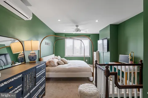 a bedroom with furniture and a large window