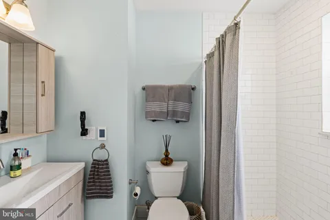 a bathroom with a sink toilet and mirror