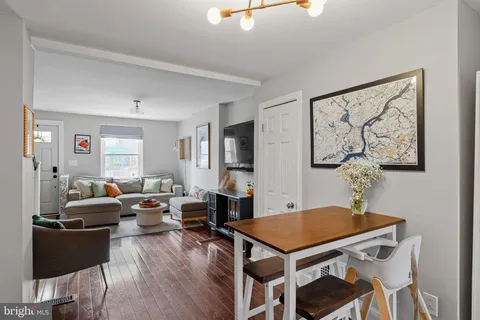 a living room with furniture a table and wooden floor