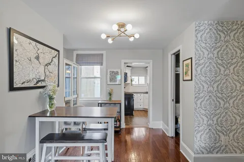 a view of a dining room with furniture and wooden floor