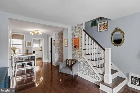 a view of entryway and hall with wooden floor