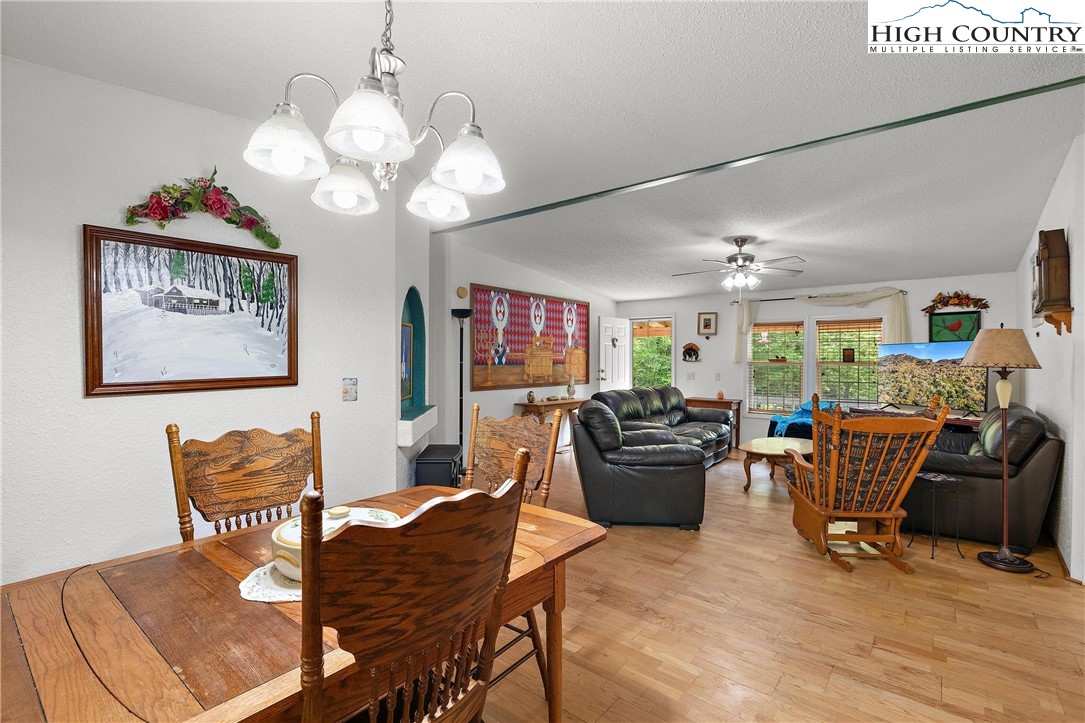 787 Lawrence Greene Road Deep Gap, NC 28618 - Photo 12 of 45 a living room with furniture kitchen and a chandelier