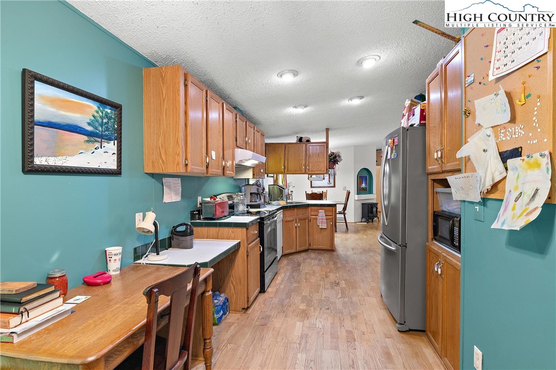 787 Lawrence Greene Road Deep Gap, NC 28618 - Photo 16 of 45 a kitchen that has a lot of cabinets a sink and appliances in it