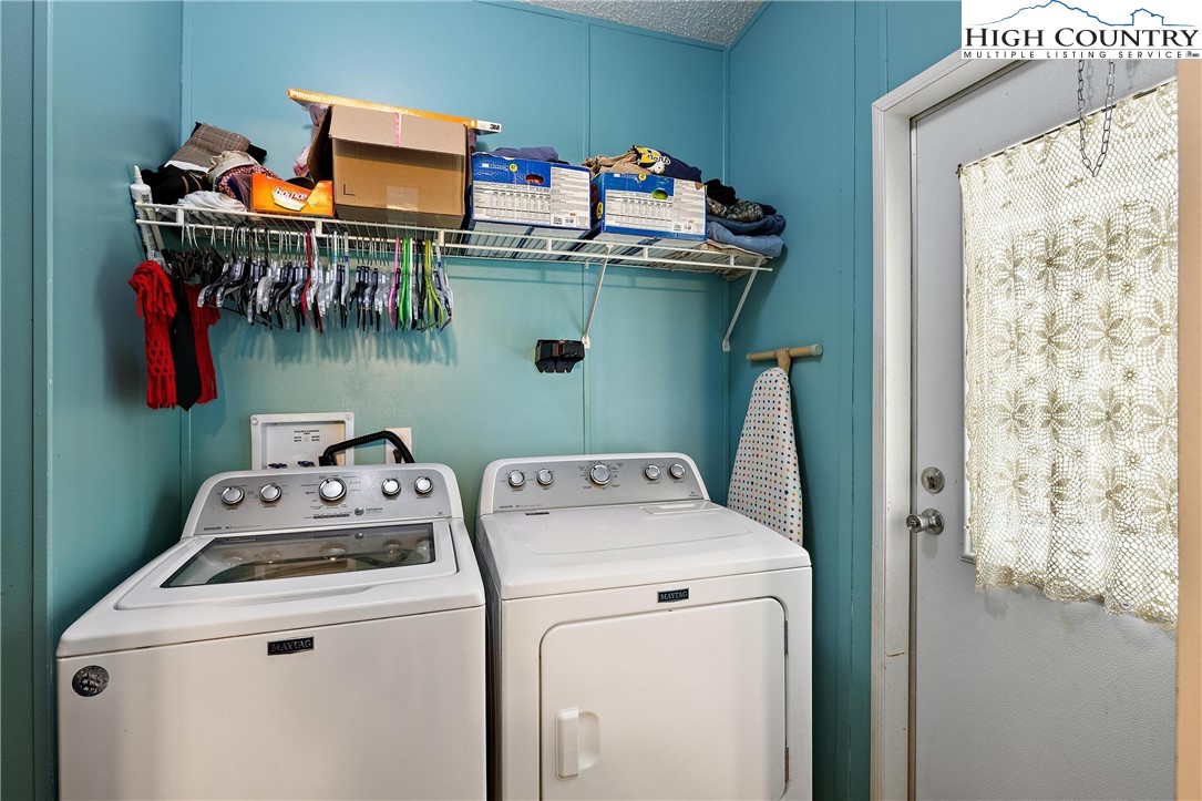 787 Lawrence Greene Road Deep Gap, NC 28618 - Photo 17 of 45 a utility room with dryer and washer