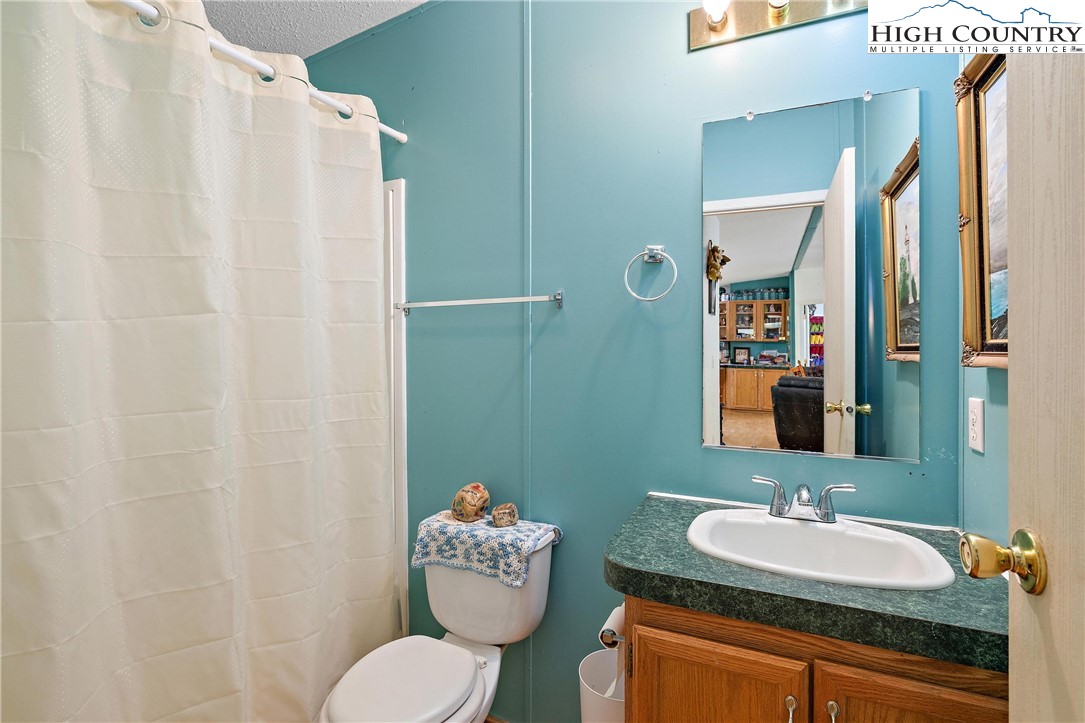 787 Lawrence Greene Road Deep Gap, NC 28618 - Photo 20 of 45 a bathroom with a sink and a mirror