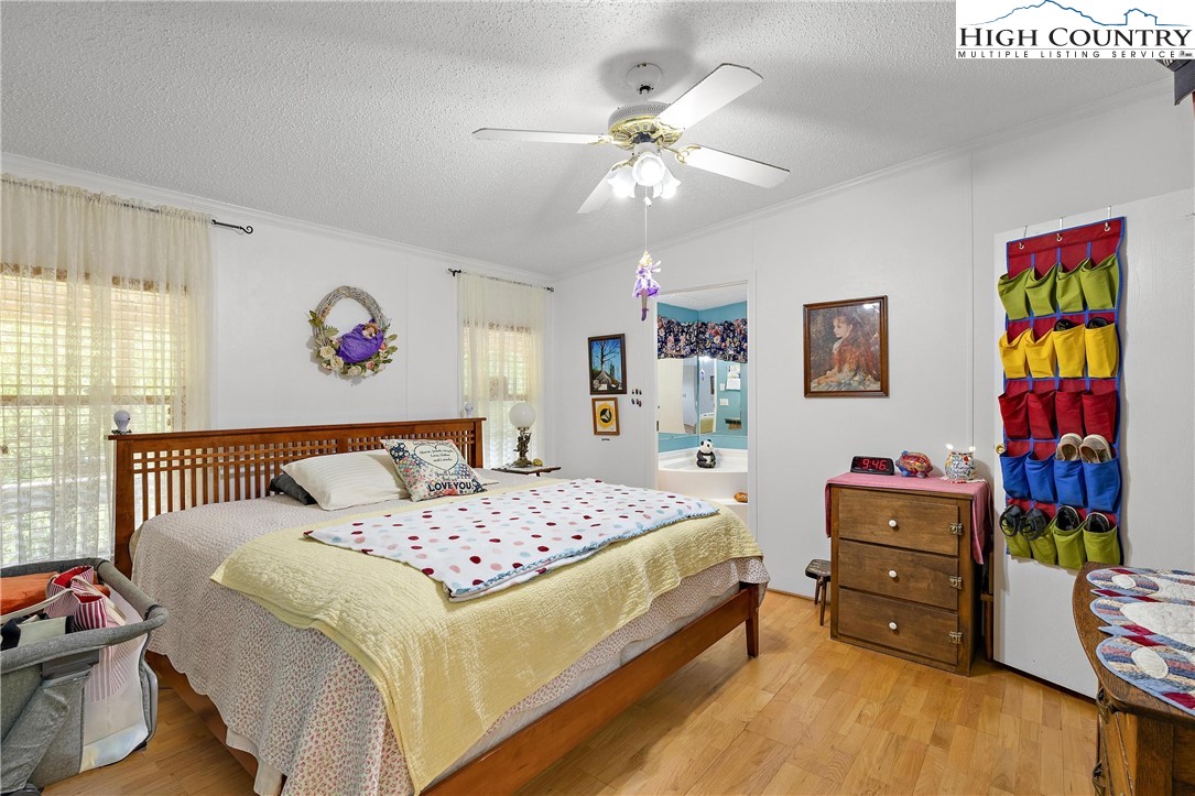787 Lawrence Greene Road Deep Gap, NC 28618 - Photo 23 of 45 a bedroom with a bed and wooden floor