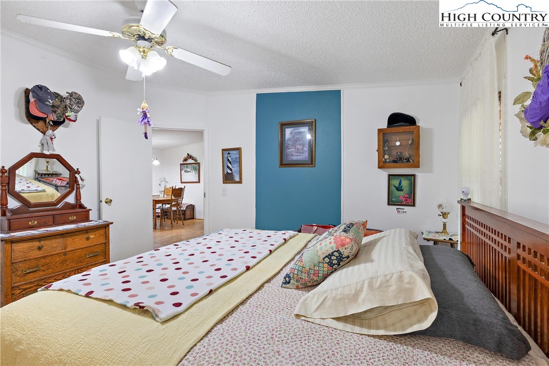787 Lawrence Greene Road Deep Gap, NC 28618 - Photo 25 of 45 a bedroom with a bed and a dresser