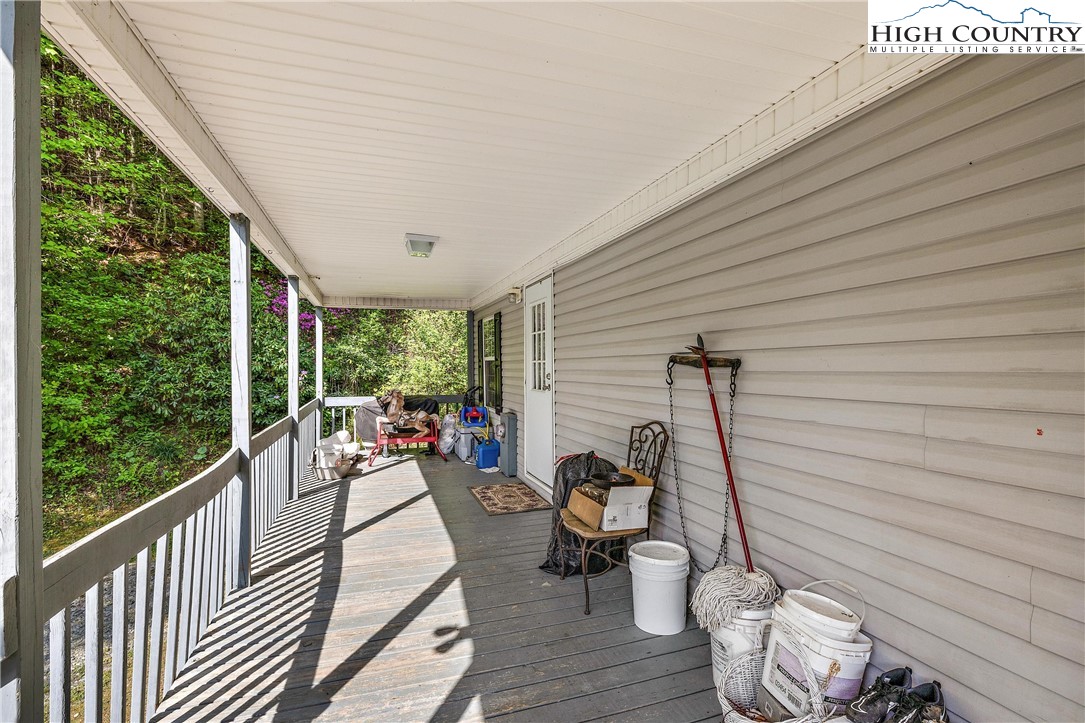 787 Lawrence Greene Road Deep Gap, NC 28618 - Photo 29 of 45 a view of a patio with wooden chairs