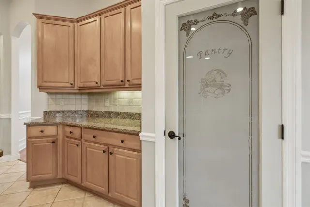 a bathroom with a granite countertop sink vanity and mirror