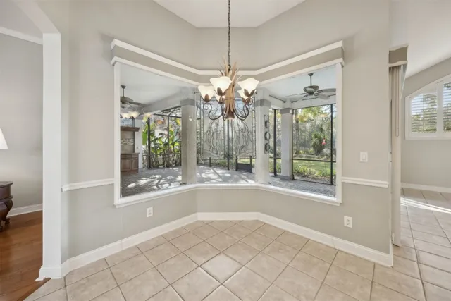 a view of a livingroom with a window and chandelier