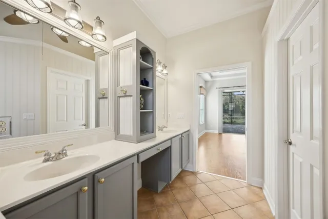 a spacious bathroom with a double vanity sink a mirror and a bathtub
