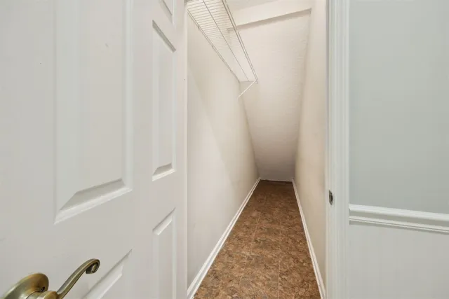 a view of a hallway with wooden floor and entryway