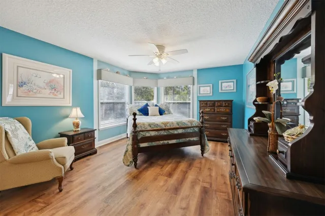 a bedroom with furniture and a wooden floor