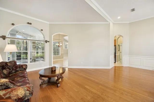 a living room with furniture and wooden floor
