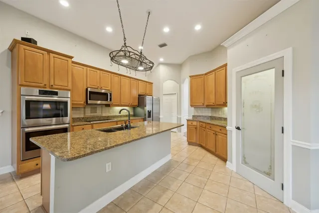 a large kitchen with granite countertop lots of counter top space