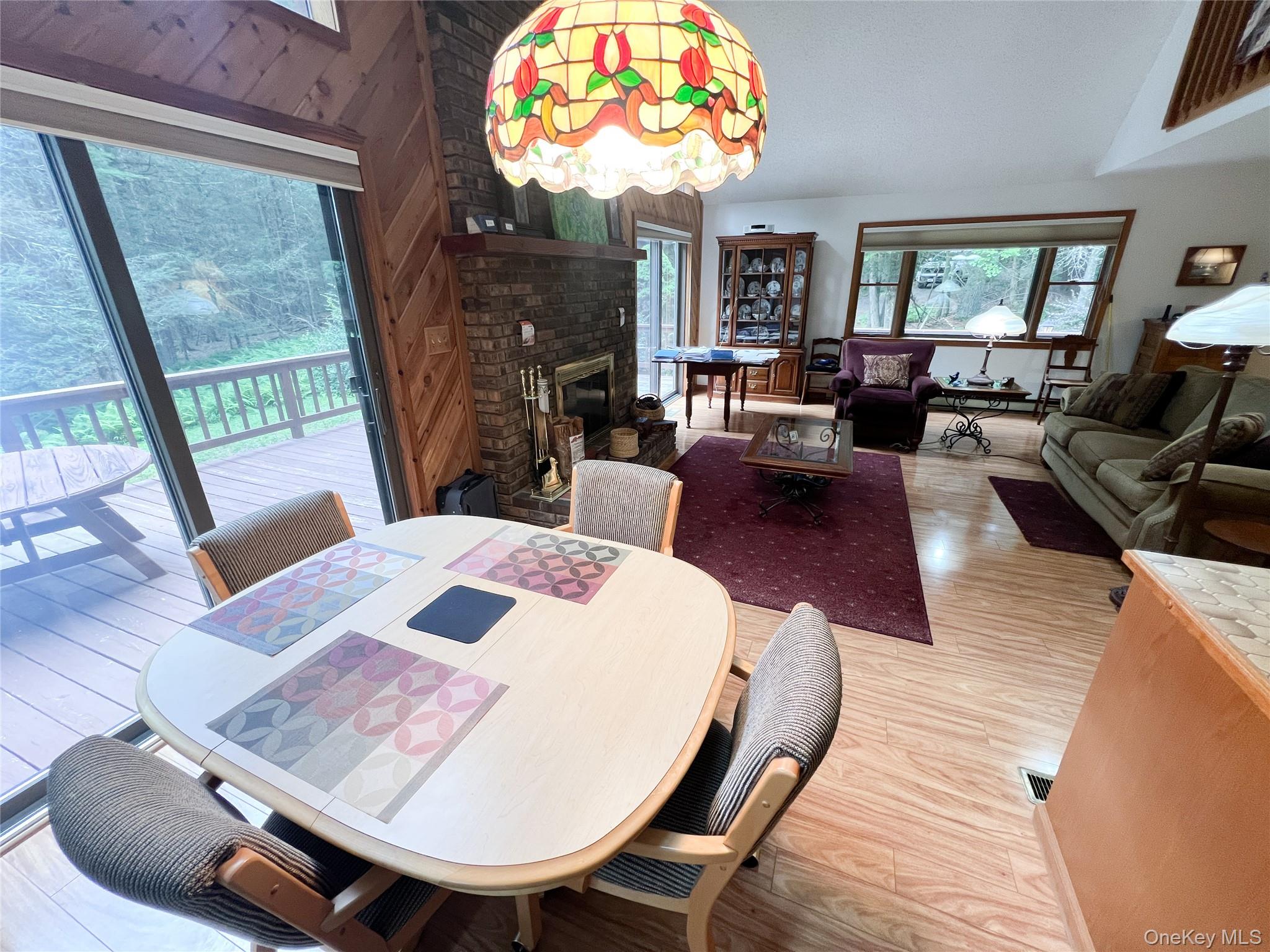 72 Black Lake Road Bethel, NY 12786 - Photo 12 of 22 a view of a dining room with furniture a chandelier and wooden floor