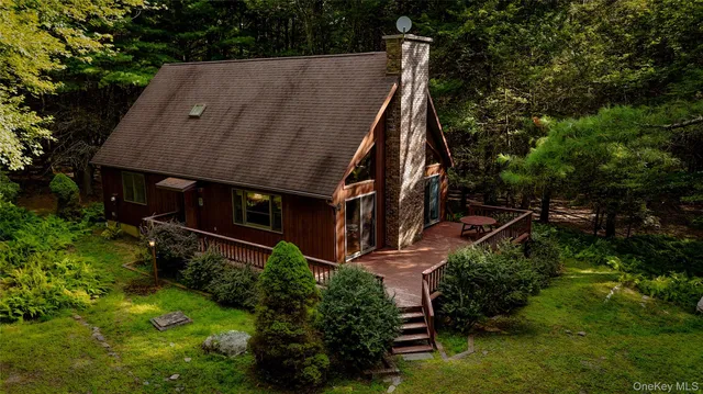 an aerial view of a house with yard table and chairs