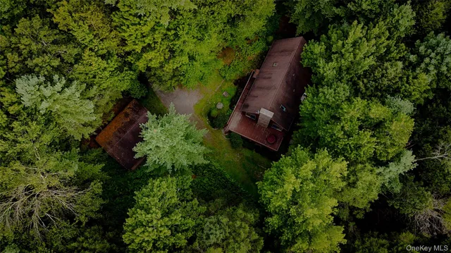 an aerial view of a house with a yard