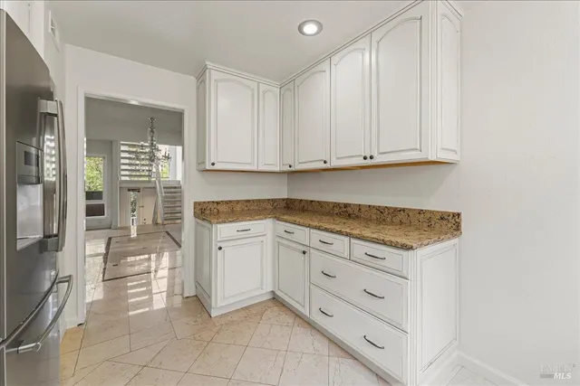 a kitchen with cabinets stainless steel appliances and a counter space