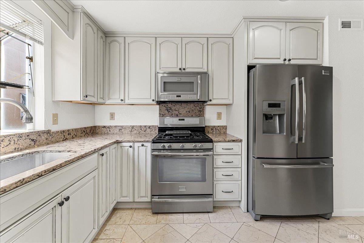 2121 Vale Road, Unit 31 San Pablo, CA 94806 - Photo 12 of 36 a kitchen with cabinets stainless steel appliances and a counter space
