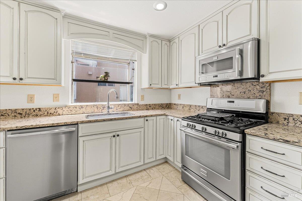 2121 Vale Road, Unit 31 San Pablo, CA 94806 - Photo 13 of 36 a kitchen with white cabinets and appliances