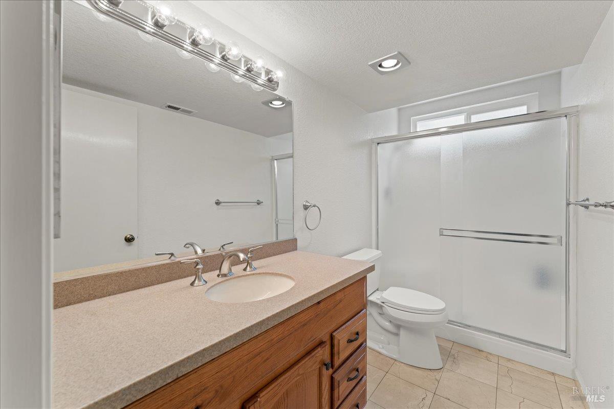 2121 Vale Road, Unit 31 San Pablo, CA 94806 - Photo 16 of 36 a bathroom with a sink toilet a mirror and shower