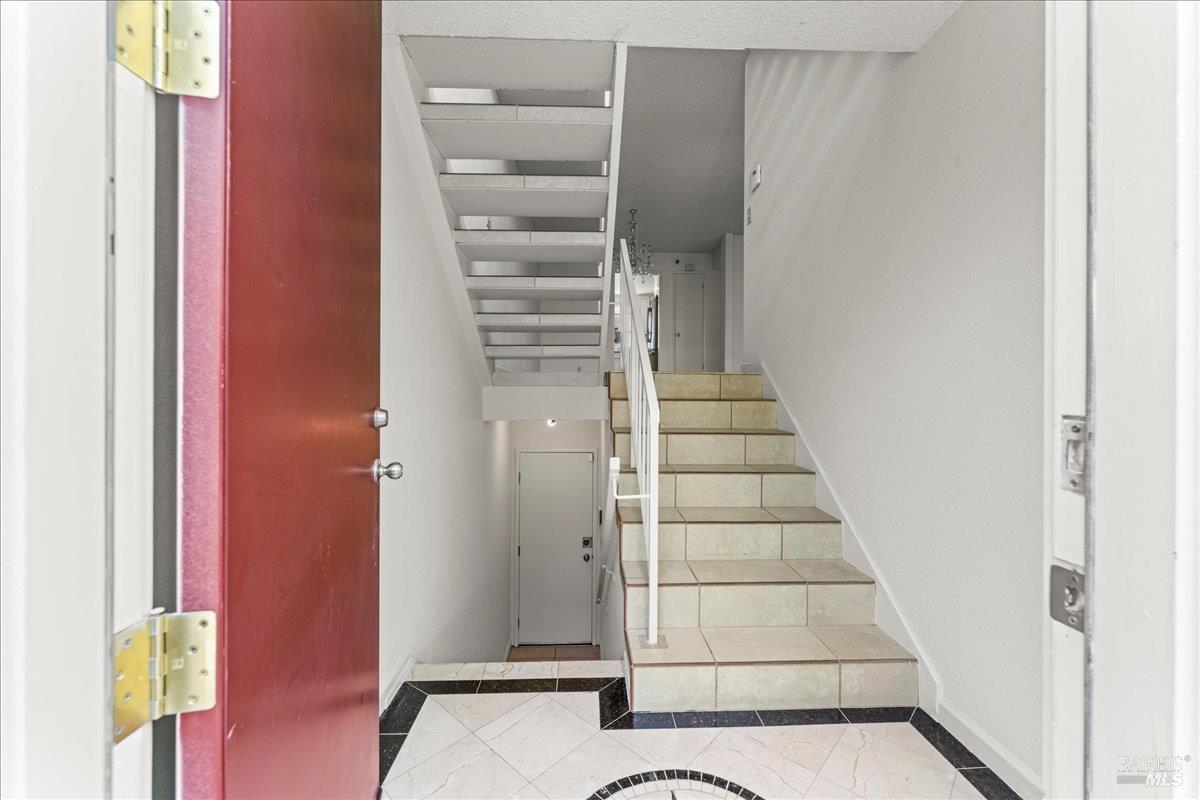 2121 Vale Road, Unit 31 San Pablo, CA 94806 - Photo 3 of 36 a view of staircase with white walls and windows