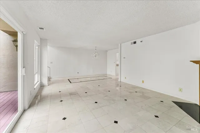 a view of empty room with wooden floor and window
