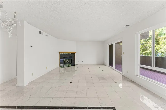 a large white kitchen with a large window