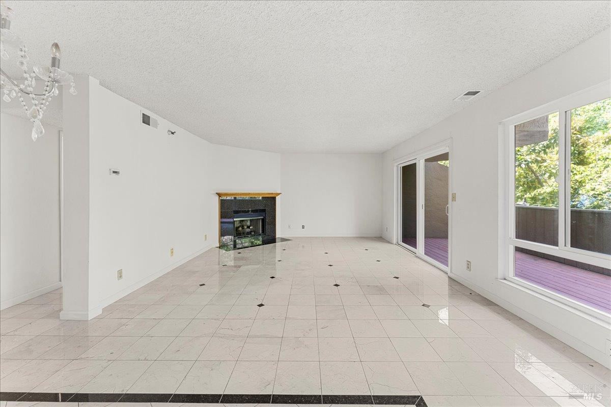 2121 Vale Road, Unit 31 San Pablo, CA 94806 - Photo 7 of 36 a view of empty room with wooden floor and window