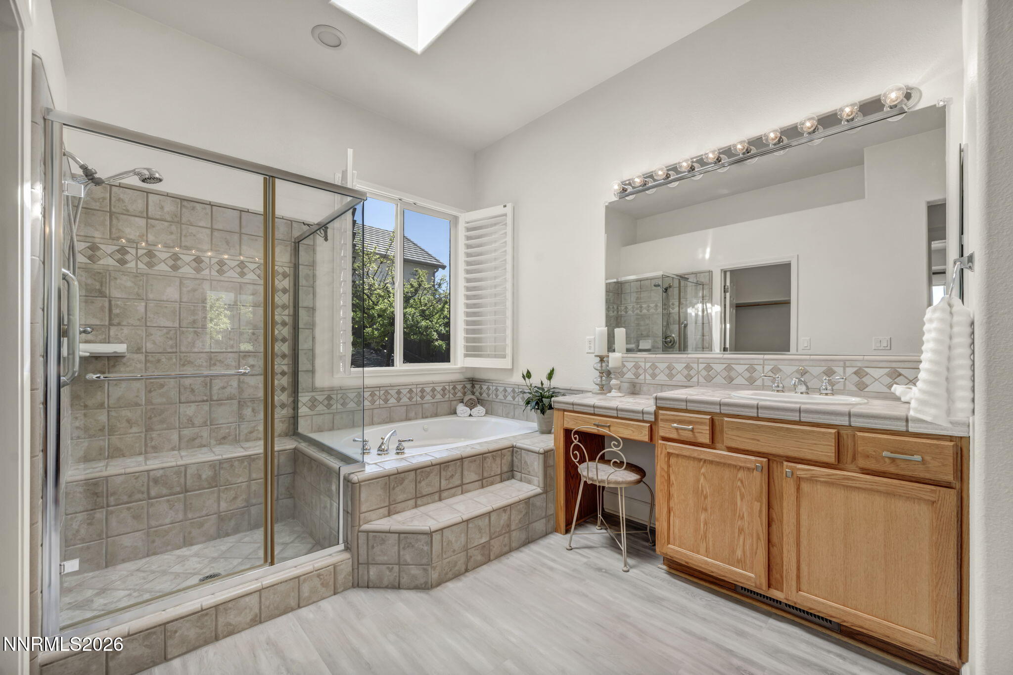 574 Echo Ridge Court Reno, NV 89511 - Photo 34 of 58 a bathroom with a tub sink shower and mirror