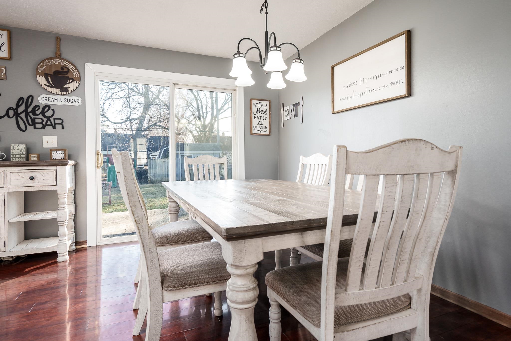 237 Theodore Street Loves Park, IL 61111 - Photo 18 of 33 a view of a dining room with furniture window and wooden floor