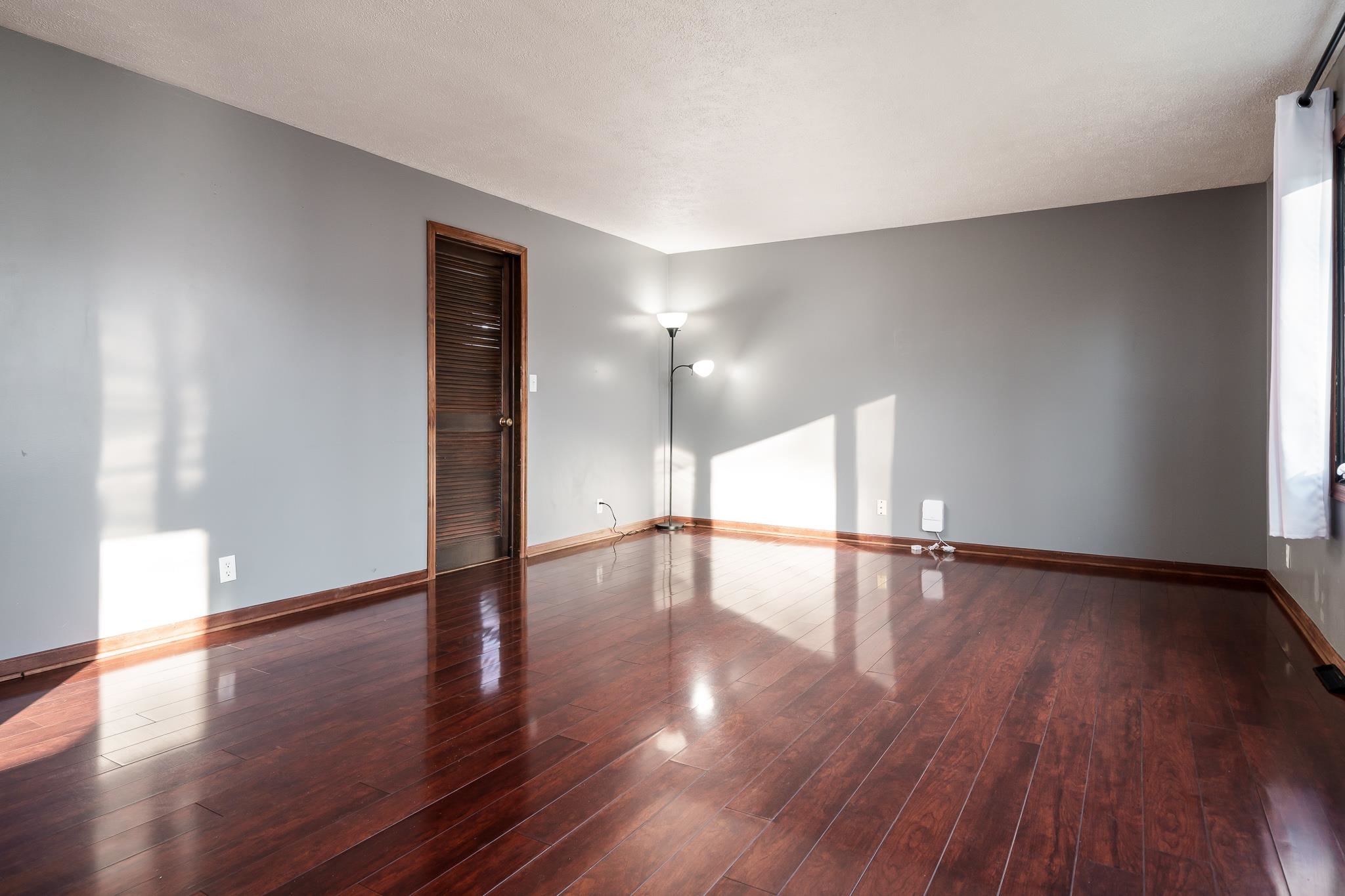 237 Theodore Street Loves Park, IL 61111 - Photo 20 of 33 a view of an empty room with wooden floor and a window