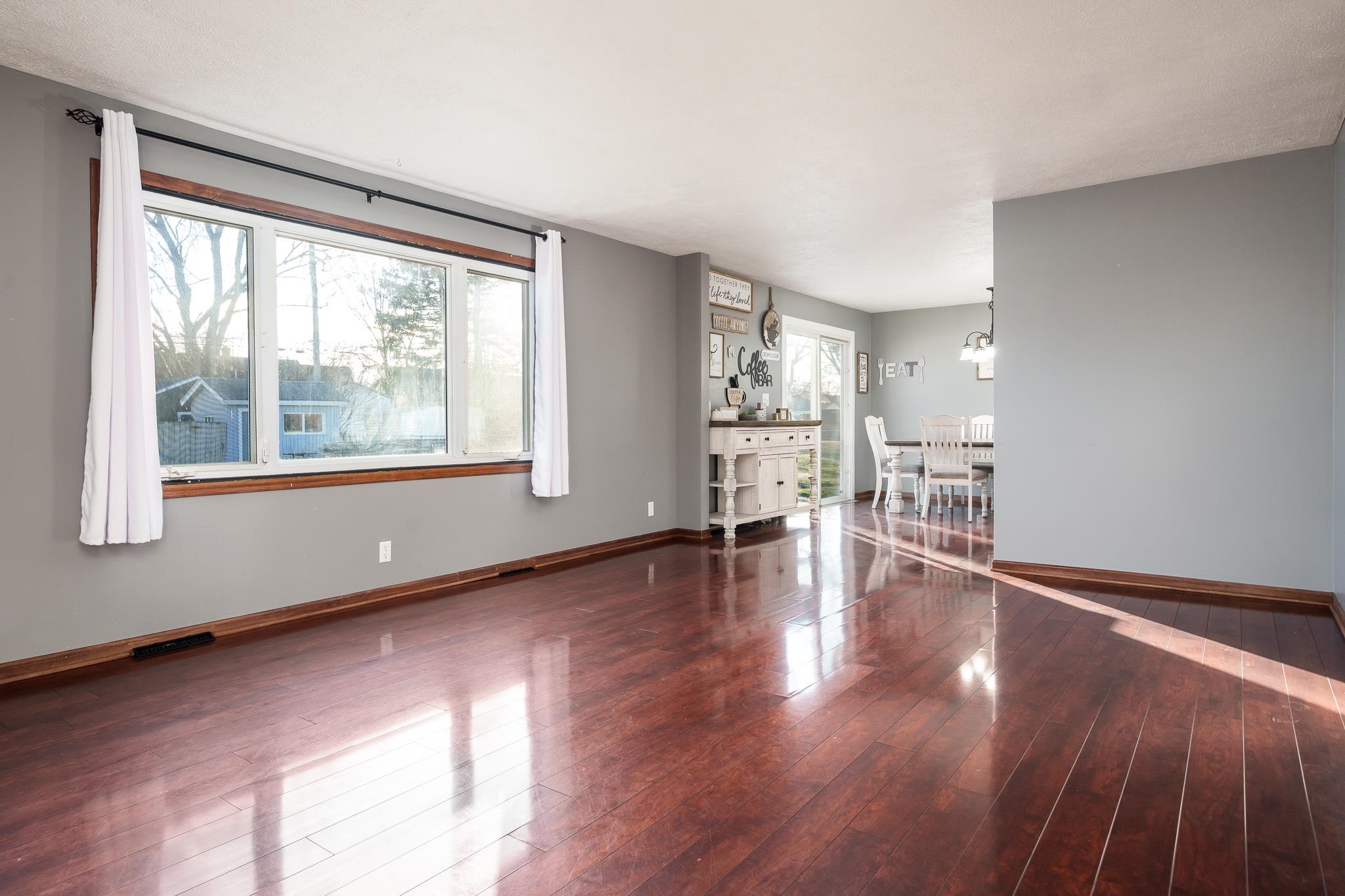 237 Theodore Street Loves Park, IL 61111 - Photo 22 of 33 a view of empty room with wooden floor and fireplace