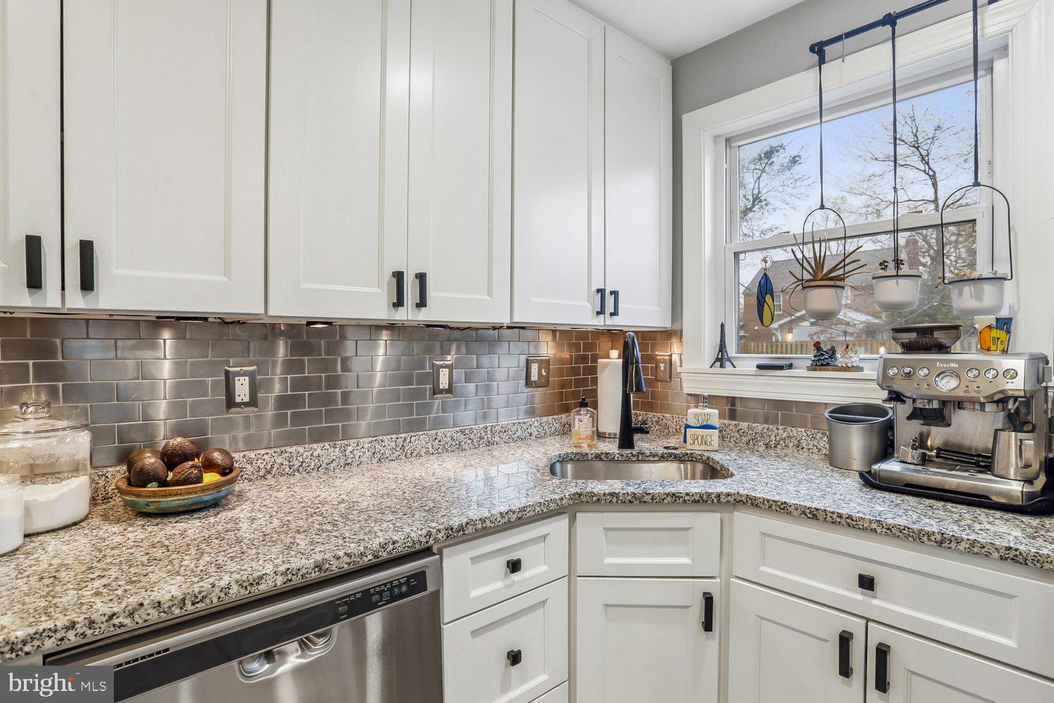 1611 Noyes Drive Silver Spring, MD 20910 - Photo 12 of 47 a kitchen with granite countertop white cabinets and white appliances