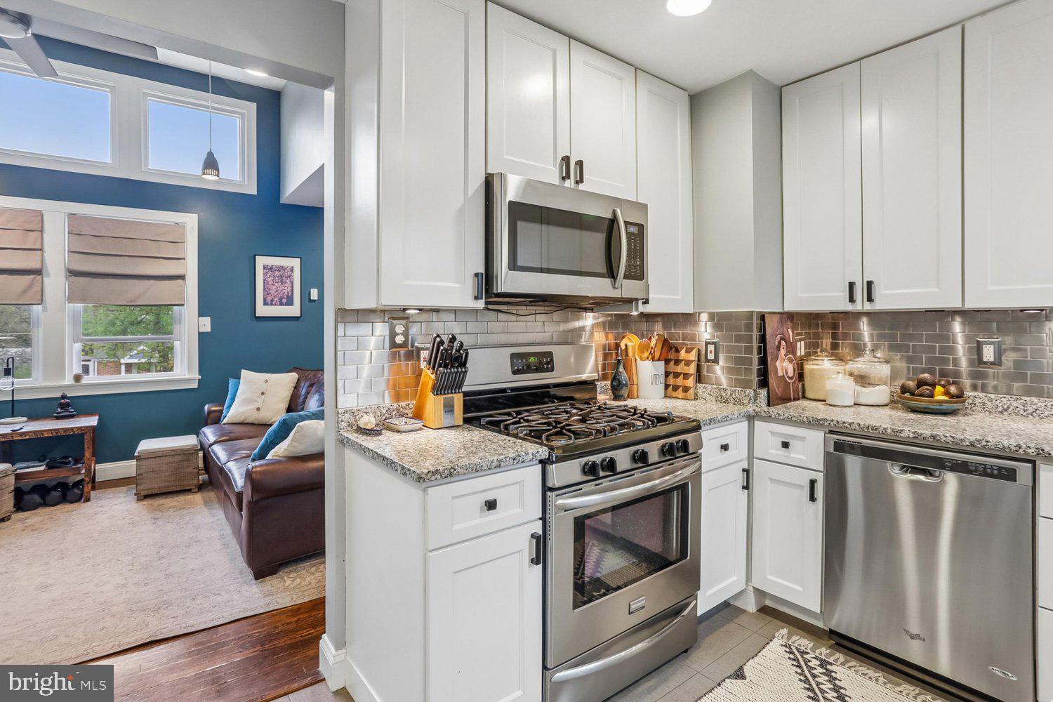 1611 Noyes Drive Silver Spring, MD 20910 - Photo 14 of 47 a kitchen with stainless steel appliances granite countertop a stove a sink and a microwave