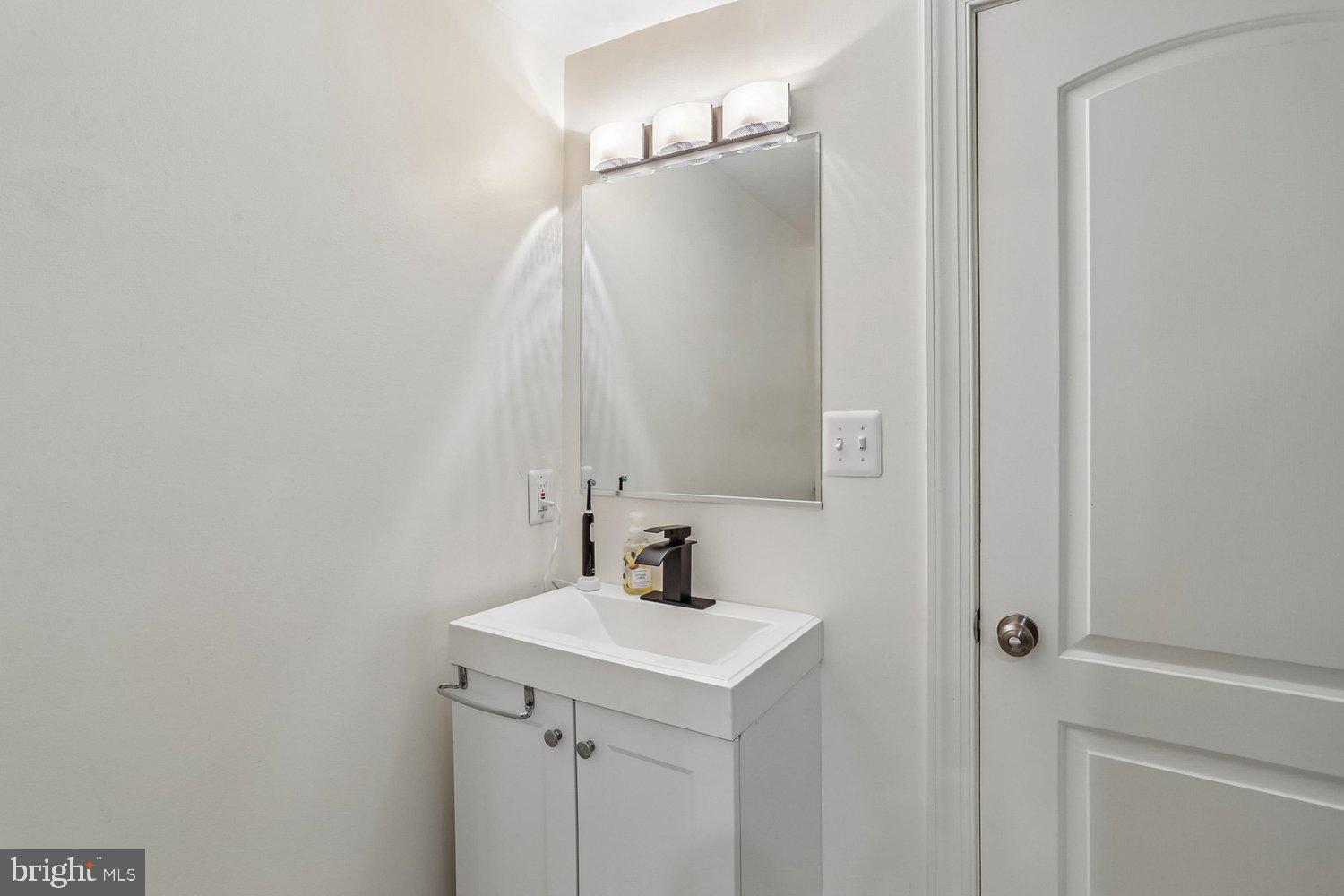 1611 Noyes Drive Silver Spring, MD 20910 - Photo 26 of 47 a bathroom with a sink and a mirror